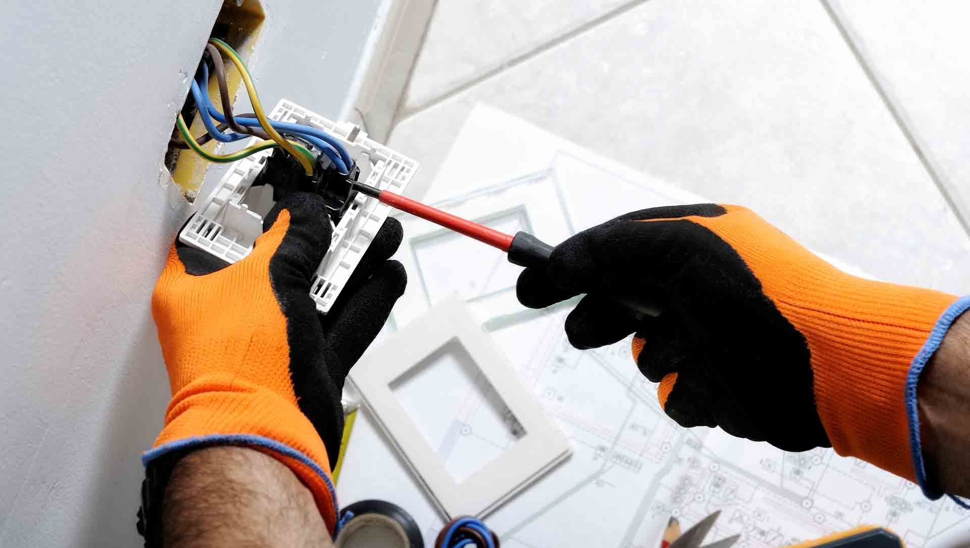 A Dublin Electrician installing a plug