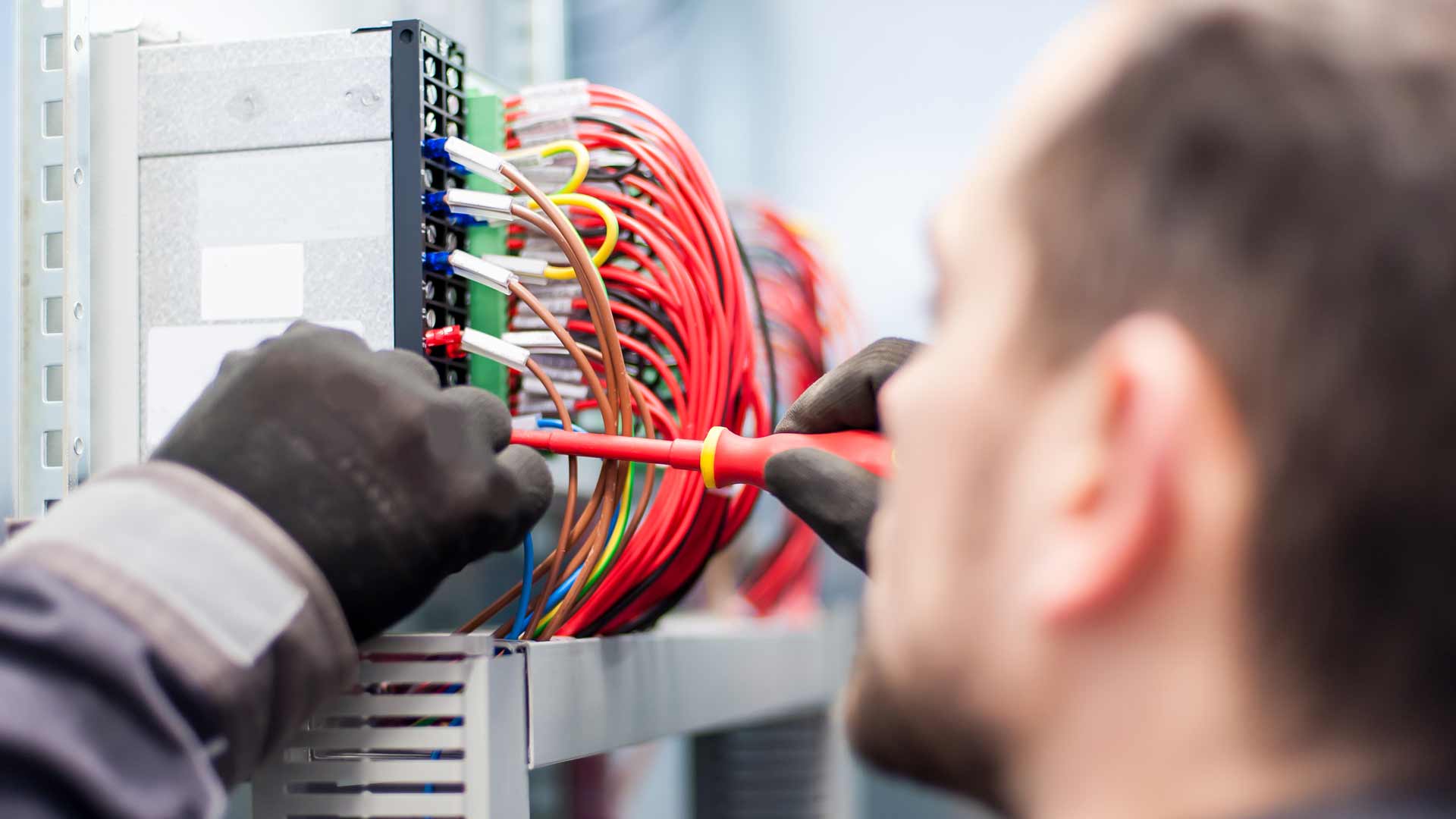 Dublin Electrican working on wires in a fuseboard 